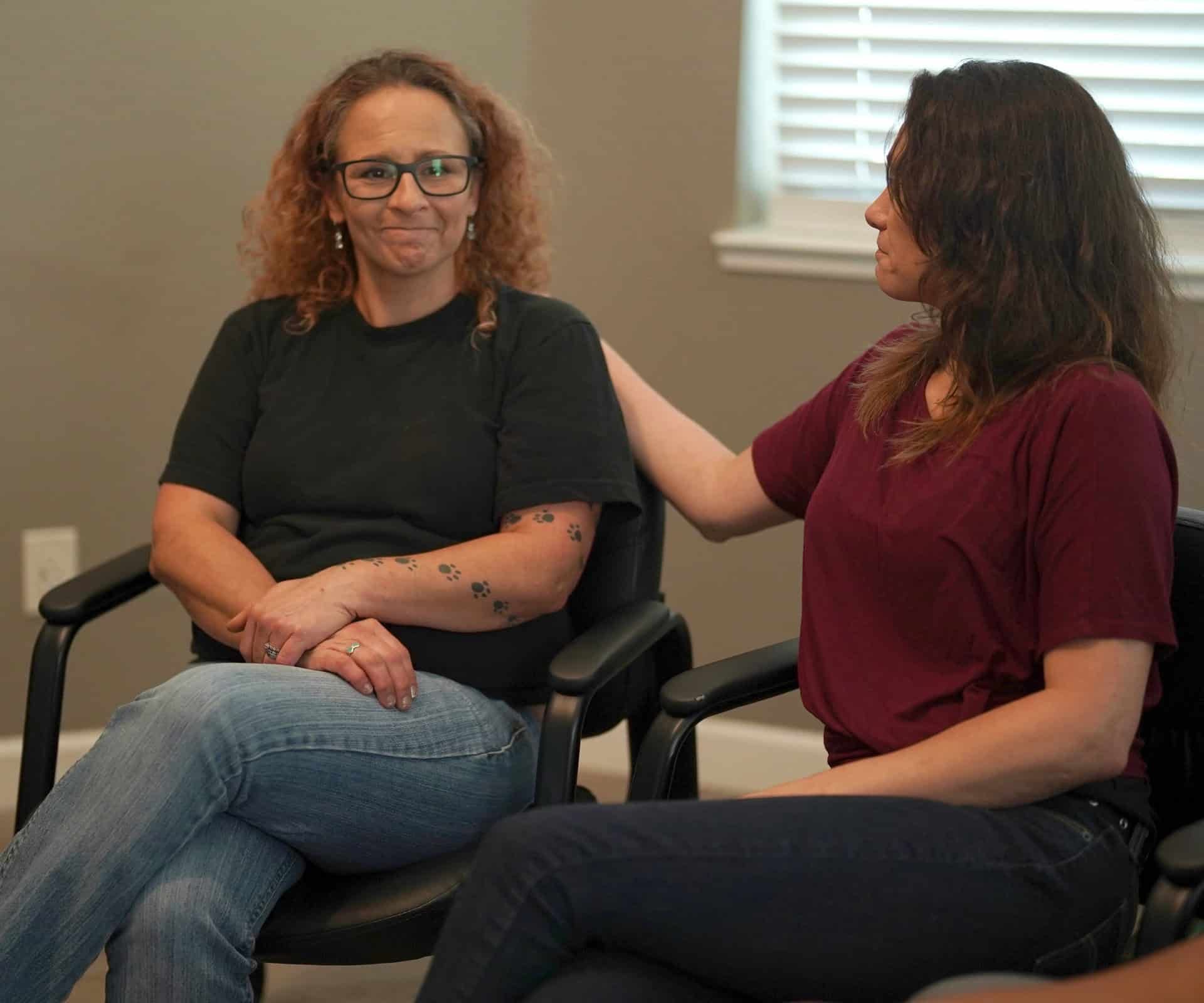 A woman receives support from a friend during dual diagnosis treatment in Monterey, CA.