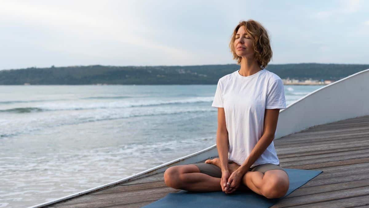 A serene woman engaged in meditation during mindfulness therapy in California.